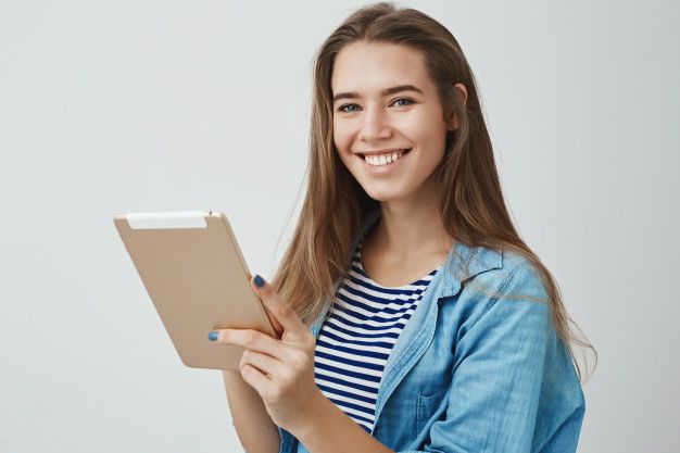 happy-friendly-gorgeous-female-assistant-smiling-broadly-holding-digital-tablet-posing-joyfully-satisfied-how-easy-draw-using-gadget_176420-14943